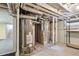 Unfinished basement shows hot water heater, furnace, and shelving at 4716 Broadway, Denver, CO 80216