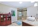 Tiled bathroom featuring a glass enclosed shower, vessel sink, and decorative storage cabinet at 4716 Broadway, Denver, CO 80216