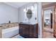 Well lit bathroom featuring granite countertops, vessel sink, and tiled bath and shower at 4716 Broadway, Denver, CO 80216