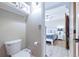Well lit water closet located off of a bedroom featuring a white toilet at 4716 Broadway, Denver, CO 80216