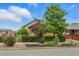 Charming home exterior with manicured landscaping and mature trees at 4716 Broadway, Denver, CO 80216