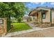 Charming home featuring a stone pillar mailbox, quaint bench, and a grass and stone yard at 4716 Broadway, Denver, CO 80216