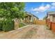 Charming home featuring a stone pillar mailbox, quaint bench, and a grass and stone yard at 4716 Broadway, Denver, CO 80216