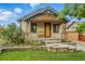 Charming home showcasing a welcoming front porch, stone accents, and a beautifully landscaped front yard at 4716 Broadway, Denver, CO 80216