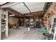 Spacious garage with exposed rafters and cement floor, ideal for workshop or storage at 4716 Broadway, Denver, CO 80216