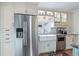 Updated kitchen with farmhouse sink, stainless steel appliances, and custom cabinetry at 4716 Broadway, Denver, CO 80216