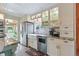 Elegant kitchen featuring white cabinets, stainless steel appliances, granite countertops, and ample storage at 4716 Broadway, Denver, CO 80216