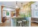 This kitchen features a breakfast bar with pendant lighting and forest-themed accent wall at 4716 Broadway, Denver, CO 80216
