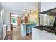 Bright kitchen with island seating, granite counters, and updated appliances and flooring at 4716 Broadway, Denver, CO 80216