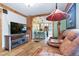 Open-concept design showcasing the living room flowing into the kitchen with hardwood floors and brick accents at 4716 Broadway, Denver, CO 80216