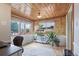 Home office featuring wood ceiling, hardwood floors, large windows and potted plants at 4716 Broadway, Denver, CO 80216