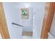 Stairwell featuring hardwood banister, stained glass window, and white walls at 4716 Broadway, Denver, CO 80216