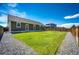 Spacious backyard with a green lawn and a well-maintained house on a sunny day at 56459 E 23Rd Pl, Strasburg, CO 80136