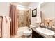Bathroom with shower-tub combo, granite countertops, decorative mirror and updated fixtures at 56459 E 23Rd Pl, Strasburg, CO 80136