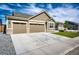 Attractive single-story home boasts a two car garage, and a concrete driveway with a nice lawn at 56459 E 23Rd Pl, Strasburg, CO 80136