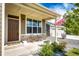 Inviting front porch showcases stone accents, outdoor seating, and a welcoming entrance to the home at 56459 E 23Rd Pl, Strasburg, CO 80136