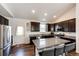 Well-equipped kitchen features stainless steel appliances, granite countertops, and ample cabinet space at 56459 E 23Rd Pl, Strasburg, CO 80136