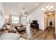 Cozy living room with vaulted ceiling and natural light at 56459 E 23Rd Pl, Strasburg, CO 80136