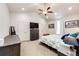 Spacious main bedroom with vaulted ceiling, ceiling fan, and ensuite bathroom entrance at 56459 E 23Rd Pl, Strasburg, CO 80136