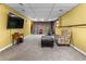 Spacious basement featuring a TV, ample seating, and a neutral carpet, ideal for entertaining and relaxation at 3280 S Ouray Way, Aurora, CO 80013
