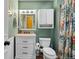 Bathroom featuring a vanity with drawers, white storage cabinet, and decorative shower curtain at 3280 S Ouray Way, Aurora, CO 80013