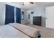 Cozy bedroom features a ceiling fan, a dresser and closet with a window view and cool blue walls at 3280 S Ouray Way, Aurora, CO 80013
