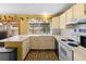 Kitchen features a large wrap-around countertop and white appliances at 3280 S Ouray Way, Aurora, CO 80013