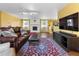 Spacious living room with a painted brick fireplace, modern lighting, and hardwood floors at 3280 S Ouray Way, Aurora, CO 80013