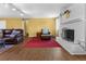 Bright and airy living room featuring a fireplace, comfortable seating, and hardwood flooring at 3280 S Ouray Way, Aurora, CO 80013