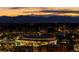 Nighttime aerial view showcasing the cityscape with lit arenas against a mountain backdrop at 1133 14Th St # 1850, Denver, CO 80202