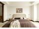Bright bedroom featuring a brown bed, bedside tables, lamps and artwork on the wall at 1133 14Th St # 1850, Denver, CO 80202