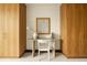 Modern home office with wooden wardrobes flanking a stylish desk and a decorative picture frame at 1133 14Th St # 1850, Denver, CO 80202