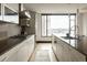 Open kitchen with modern appliances, a large island, and views of the city skyline at 1133 14Th St # 1850, Denver, CO 80202
