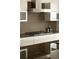 Modern kitchen featuring sleek cabinetry, stainless steel appliances, and a stylish backsplash at 1133 14Th St # 1850, Denver, CO 80202