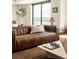 Modern living room featuring a plush leather sofa, city views, and chic coffee table decor at 1133 14Th St # 1850, Denver, CO 80202