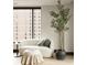 Cozy living space with a modern sofa, accent chair, and a view of the city at 1133 14Th St # 1850, Denver, CO 80202