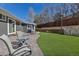 Relaxing backyard features artificial turf and a patio seating area, ideal for entertaining at 3604 Collins St, Castle Rock, CO 80108