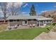 Spacious backyard with a patio, seating area, and lush artificial grass, great for entertaining at 3604 Collins St, Castle Rock, CO 80108