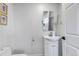 Clean half bathroom featuring a toilet and vanity with sink, ideal for guests at 3604 Collins St, Castle Rock, CO 80108