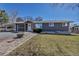 Charming single-story home with gray siding, a carport, and a well-maintained lawn at 3604 Collins St, Castle Rock, CO 80108