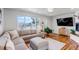 Bright living room featuring hardwood floors, large windows, and a comfortable sectional sofa at 3604 Collins St, Castle Rock, CO 80108