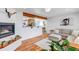 Cozy living room showcasing hardwood floors, a fireplace, and seamless flow to the kitchen at 3604 Collins St, Castle Rock, CO 80108