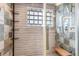Modern shower featuring stylish tile work, glass block window, and a built-in bench for added comfort at 3604 Collins St, Castle Rock, CO 80108