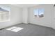 Sun-drenched bedroom with gray carpet and large windows offering natural light at 1311 Rock Cliff Ave, Erie, CO 80516