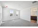 Bright bedroom with two windows, neutral paint, and adjacent bathroom entrance at 1311 Rock Cliff Ave, Erie, CO 80516
