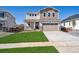 Charming two-story home featuring a well-manicured lawn and an attached two-car garage at 1311 Rock Cliff Ave, Erie, CO 80516