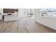 Open-concept kitchen with island, stainless steel appliances, and natural light from sliding glass doors at 1311 Rock Cliff Ave, Erie, CO 80516
