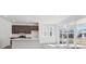 Bright kitchen features a quartz island, stainless appliances, and sliding glass doors to the backyard at 1311 Rock Cliff Ave, Erie, CO 80516