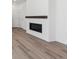 Bright living space featuring a modern fireplace and wood-look floors at 1311 Rock Cliff Ave, Erie, CO 80516