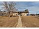 Spacious backyard featuring a patio, mature trees, and potential for landscaping at 2700 W 91St Ave, Denver, CO 80260
